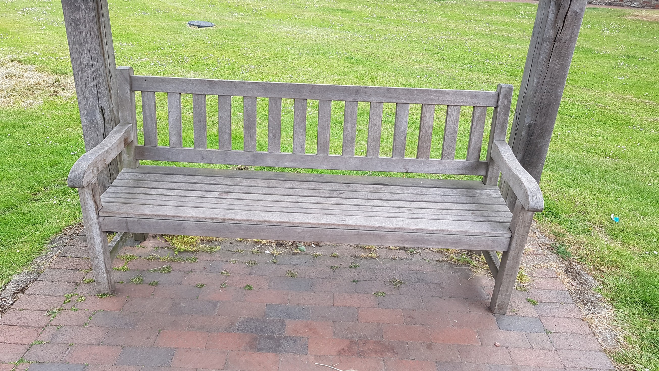 bench-in-bus-shelter-on-green